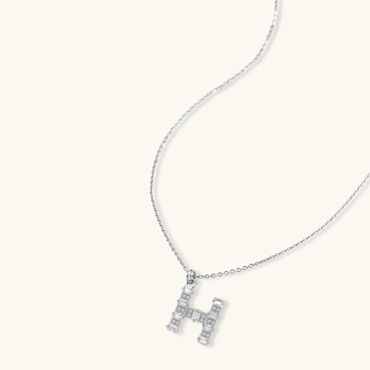 Letter H jewelry set featuring geometric crystal design in gold and white gold plated finish with adjustable chain necklace